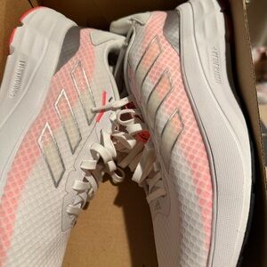 Never worn white pink colors as you can see